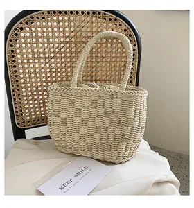 Detail of hand-woven straw beach bag with drawstring liner and round woven handles