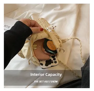 Detail of straw bag interior showing drawstring closure and storage capacity for essentials