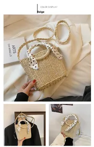 Detail of beige straw handbag with decorative silk scarf handle and woven strap for beach