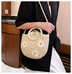 Handmade straw bag with white daisy appliques and practical secure drawstring liner