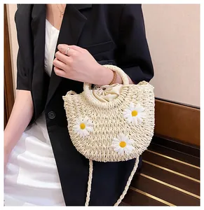 Detail of handmade straw bag with 3D white daisy flowers and drawstring lining