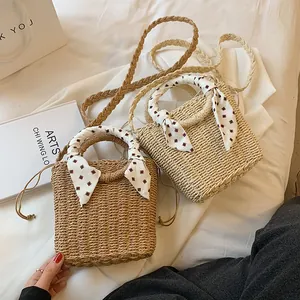 Handmade straw bucket bags in natural and beige colors with decorative silk scarves