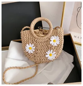 Detail of handmade straw bag with 3D daisy flowers and secure drawstring inner liner