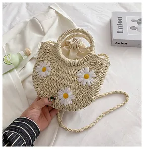 Detail of straw woven bag with 3D daisy flowers and secure drawstring inner liner