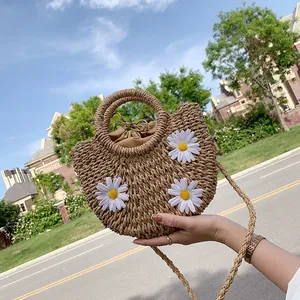 Handmade straw tote bag with white daisy flowers for summer beach vacation styling