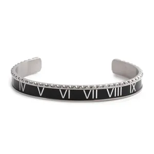 Detail of silver stainless steel cuff bracelet with black enamel Roman numerals and knurled edge