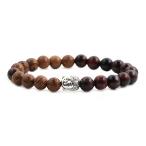 Macro shot of 8mm tiger eye stone beads and silver Buddha head on a beaded bracelet
