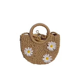 Handmade straw basket bag with white daisy flowers and drawstring lining for summer beach