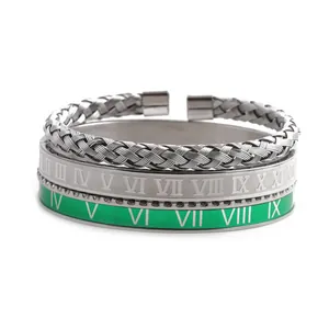 Detail view of Roman numeral engraved bangles and twisted steel cuff bracelet set