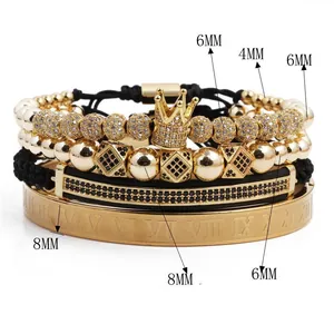 Detailed view of gold crown skull bracelet set with roman numerals and black stones