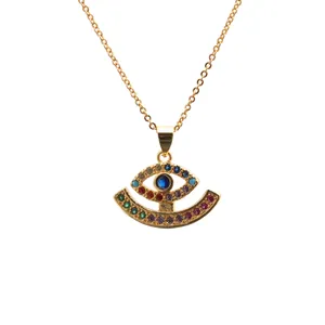Golden evil eye necklace with colorful rhinestones and deep blue center stone