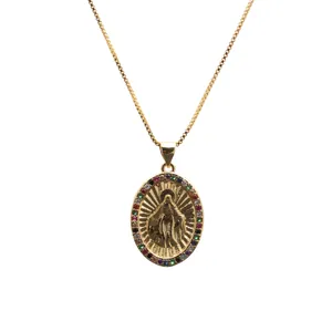 Detailed macro view of gold plated Virgin Mary pendant necklace with colorful zirconia