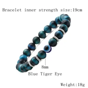Detail of 8mm blue tiger eye beads and evil eye charm on 19cm handmade beaded bracelet