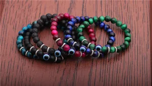 Detail of 8mm tiger eye beads and evil eye charms on elastic men's bracelets