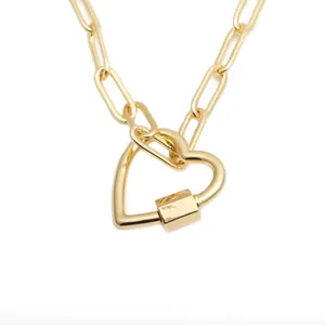 Golden paperclip chain necklace featuring a modern heart carabiner lock pendant