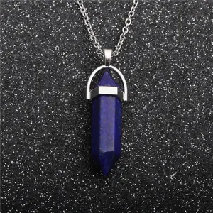 Macro detail of a hexagonal lapis lazuli cone pendant with silver chain necklace