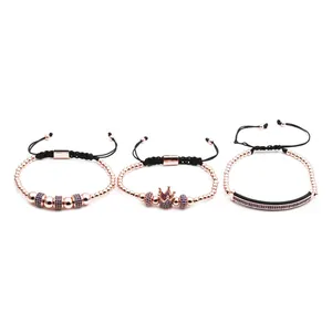 Detail of three rose gold beaded bracelets with blue cubic zirconia crown charms
