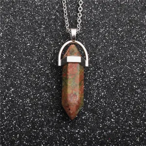 Macro shot of green and red Unakite hexagonal prism stone pendant on silver chain