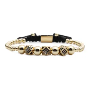 Detail of adjustable gold bead bracelet with three blue zircon geometric charms