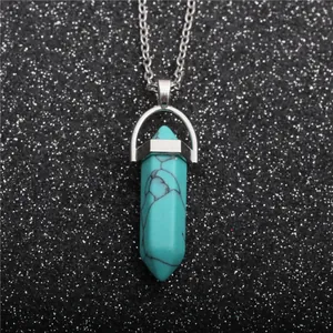 Conical turquoise stone pendant necklace with silver chain on sparkling black background
