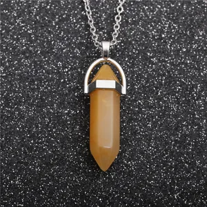Detailed view of a yellow hexagonal crystal pendant with a polished silver metal chain