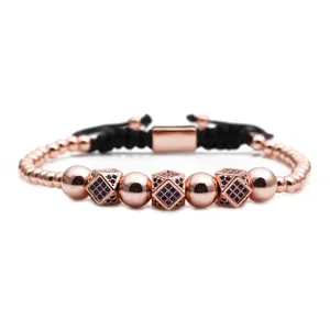 Detail of rose gold beaded bracelet with blue zircon cubic charms and adjustable cord