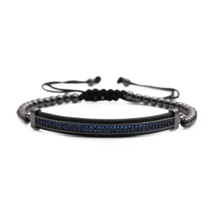 Macro view of adjustable woven bracelet with blue zircon inlay on black metal bar
