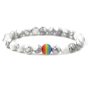 Handmade beaded bracelet with white turquoise stones and a colorful rainbow bead center