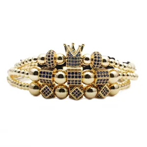 Close-up of three-layer gold beaded bracelet set with blue zircon crown and charms