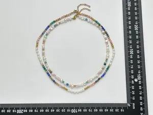 Detail of natural freshwater pearl and colorful gemstone necklace with gold-plated clasp