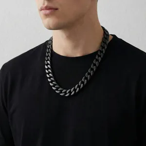 Mens black 15mm flat Cuban link chain necklace in hip-hop style worn by a male model