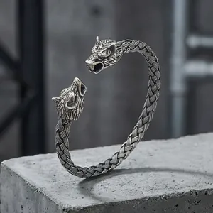 Detailed view of punk wolf head open bracelet with vintage woven metal texture