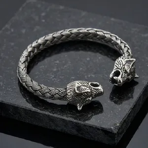 Detail of vintage silver braided stainless steel cuff featuring dual wolf head design