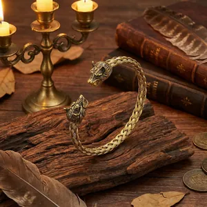 Viking style wolf head bangle with twisted texture on rustic wooden background