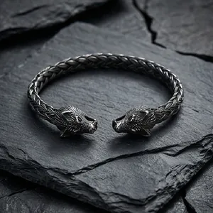 Detailed view of punk style stainless steel skull open bracelet with braided metal texture