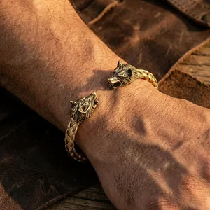 Detail of vintage wolf head cuff bracelet with intricate braided pattern on the band