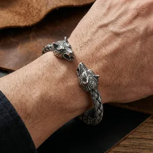 Close-up of vintage wolf head stainless steel bangle with woven texture design