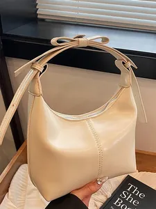 Minimalist cream crescent shoulder bag with bow detail and smooth PU leather finish