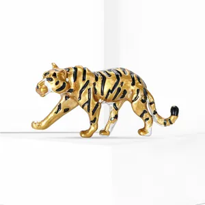 Macro detail of golden enamel tiger brooch with realistic black stripes on white stand
