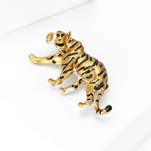 Elegant gold tiger brooch with black enamel stripes on a clean white background