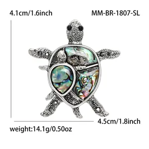 Exaggerated turtle brooch with abalone shell inlay and black crystals in antique silver