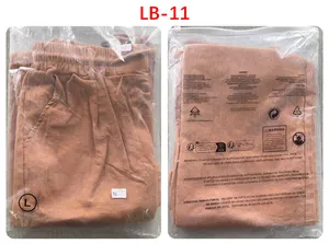 Detailed view of men's loose cotton linen trousers in orange packaging with drawstring