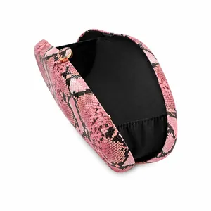 Detail view of pink snakeskin acrylic evening clutch bag showing black interior lining.