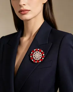 Close-up of a luxury floral brooch with red ruby crystals on a navy blue blazer lapel