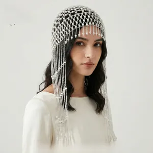 Detail of handmade pearl mesh headpiece with long elegant fringe tassels for bridal styling