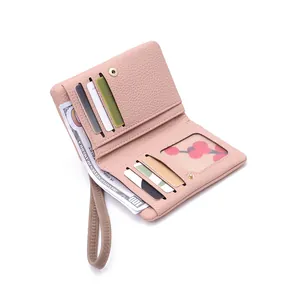 Detail of pink pebbled leather wallet showing six card slots and clear ID window