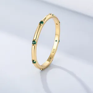 Macro detail of gold S925 sterling silver ring with green zircon stones and 925 hallmark