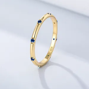 Elegant gold plated S925 silver ring with small round blue zircon stones on a slim band