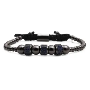 Detail of adjustable men's beaded bracelet with blue zircon cylinders and black cord
