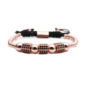 Detail of rose gold beaded bracelet with blue zircon cubes and black adjustable rope